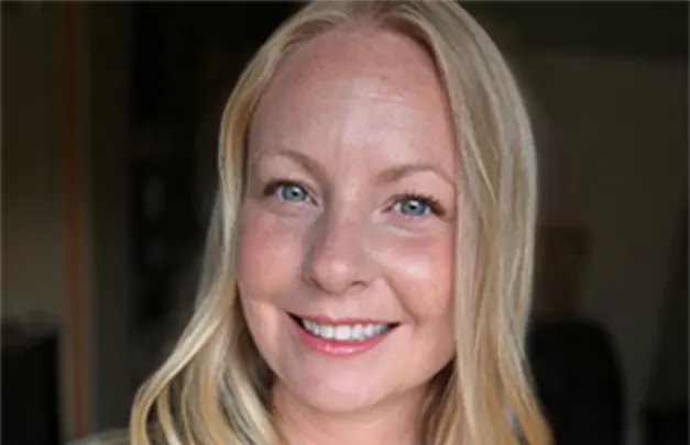Smiling blonde woman in medical scrubs